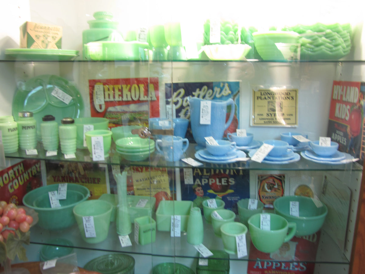 A display of opaque jade-green jadeite glass tableware and kitchenware