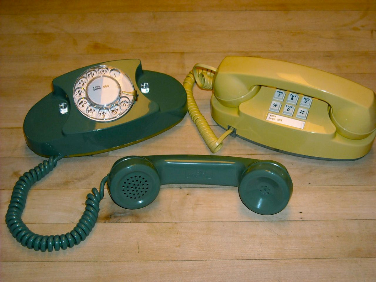 A group of Western Electric Princess telephones in several colors, showing the compact oval base and center dial.