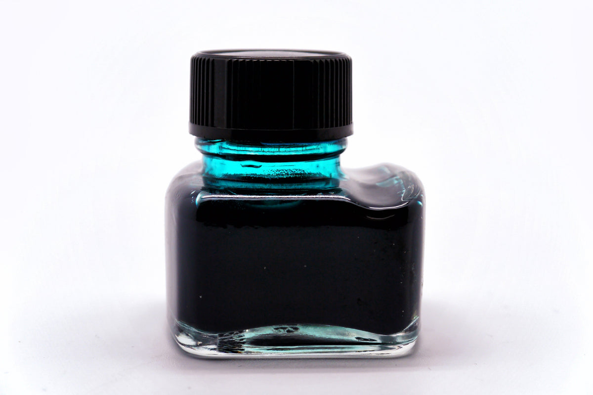A green glass vintage ink bottle, illustrative, via Wikimedia Commons