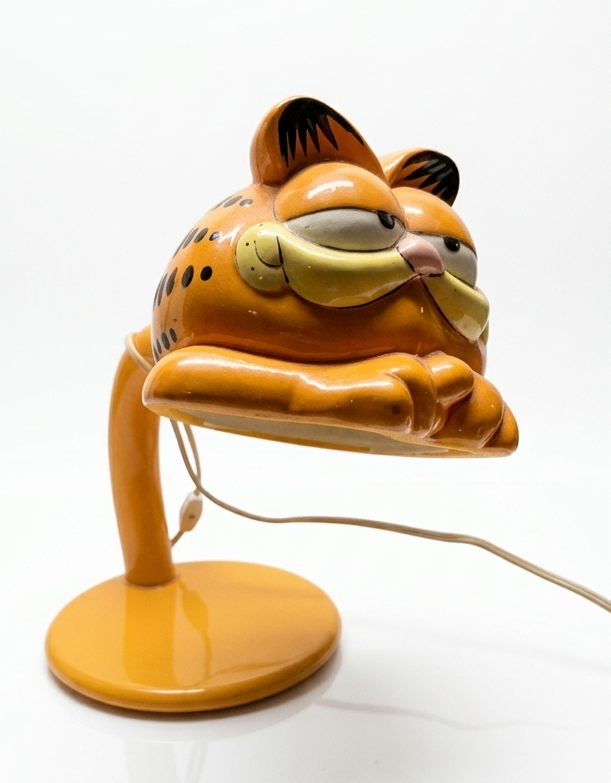 Prestigeline Garfield desk lamp, model PT-5655 — hand-decorated ceramic shade in the shape of Garfield's head and folded arms on an orange gooseneck with a weighted enamel base
